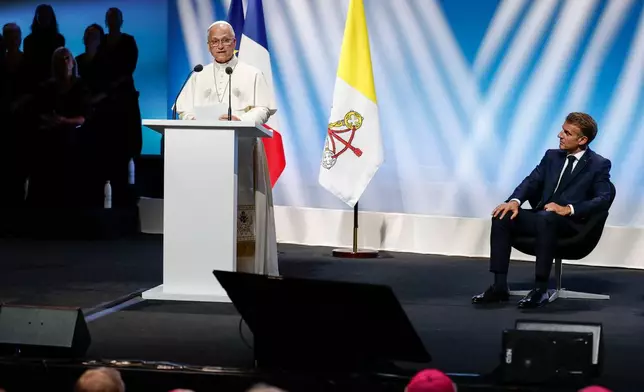 French President Emmanuel Macron looks on as Pope Leo XIV speaks at the meeting "At the Roots of Europe for Peace and Unity", in Metz, France, Monday, Sept. 28, 2026. (Benoit Tessier/Pool Photo via AP)