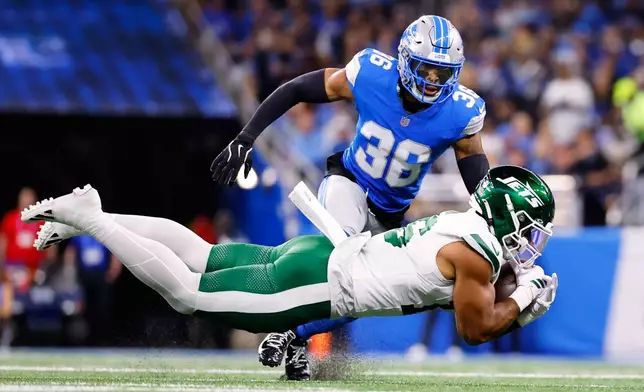 New York Jets' Kenyon Sadiq tries to catch a pass in front of Detroit Lions' Chuck Clark during the first half of an NFL football game in Detroit, Sunday, Sept. 27, 2026. (AP Photo/Ray Del Rio)
