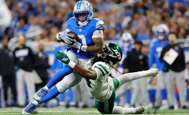 Detroit Lions' Jahmyr Gibbs tries to get past New York Jets' Jamien Sherwood during the first half of an NFL football game in Detroit, Sunday, Sept. 27, 2026. (AP Photo/Ray Del Rio)