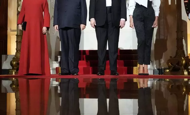 President Donald Trump and first lady Melania Trump pose for a photo with China's President Xi Jinping and his wife Peng Liyuan in the Grand Foyer of the White House during a State Dinner, Thursday, Sept. 24, 2026, in Washington. (AP Photo/Alex Brandon)