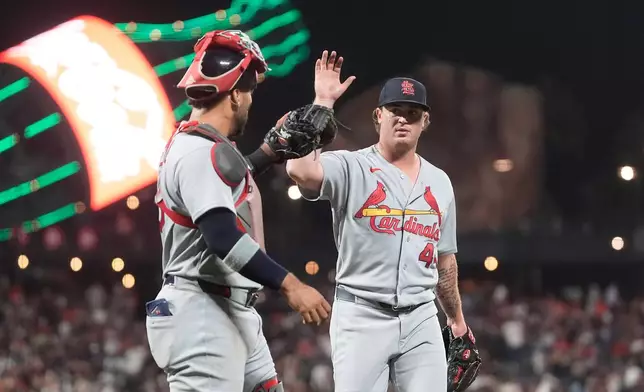 St. Louis Cardinals catcher Leo Bernal, left, celebrates with pitcher Gordon Graceffo after San Francisco Giants' Jung Hoo Lee flew out to end the seventh inning of a baseball game, Tuesday, Sept. 8, 2026, in San Francisco. (AP Photo/Jeff Chiu)