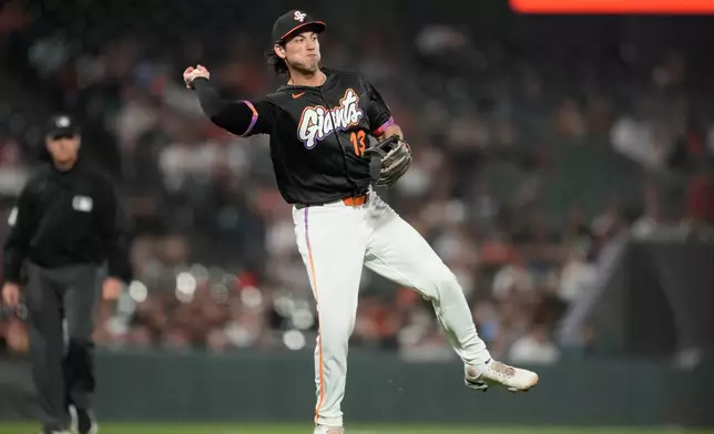 San Francisco Giants third baseman Shay Whitcomb throws out St. Louis Cardinals' Masyn Winn at first base during the seventh inning of a baseball game, Tuesday, Sept. 8, 2026, in San Francisco. (AP Photo/Jeff Chiu)