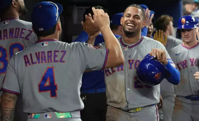 New York Mets' Christopher Morel celebrates after scoring during the second inning of a baseball game against the Miami Marlins Wednesday, Sept. 9, 2026, in Miami. (AP Photo/Marta Lavandier)