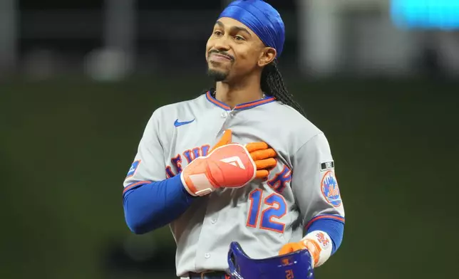 New York Mets shortstop Francisco Lindor (12) gestures during the eighth inning of a baseball game against the Miami Marlins Wednesday, Sept. 9, 2026, in Miami. (AP Photo/Marta Lavandier)