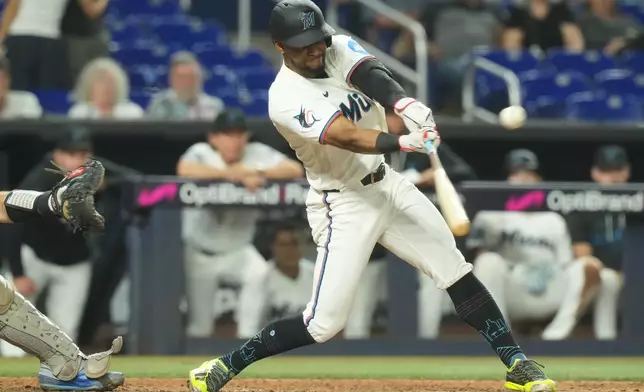 Miami Marlins' Otto Lopez hits a triple to right field during the ninth inning of a baseball game against the New York Mets Wednesday, Sept. 9, 2026, in Miami. (AP Photo/Marta Lavandier)
