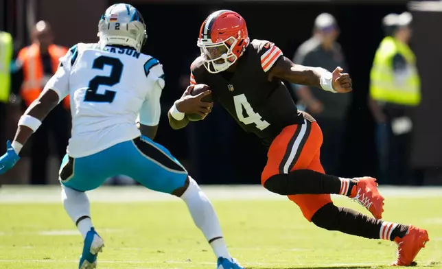 Cleveland Browns quarterback Deshaun Watson (4) runs with the ball against Carolina Panthers cornerback Mike Jackson (2) during the first half of an NFL football game in Cleveland, Thursday, Aug. 27, 2026. (AP Photo/Sue Ogrocki)