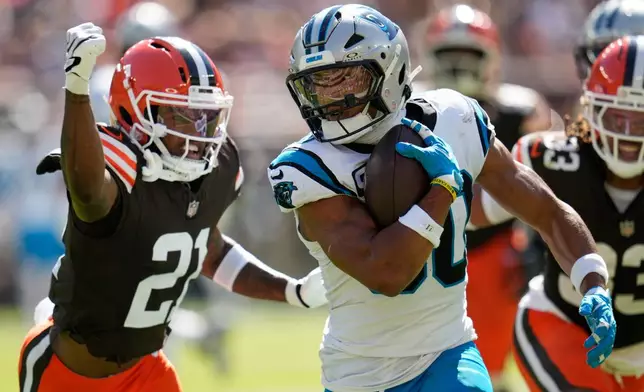 Carolina Panthers running back Chuba Hubbard (30) runs against Cleveland Browns cornerback Denzel Ward (21) during the first half of an NFL football game in Cleveland, Thursday, Aug. 27, 2026. (AP Photo/Sue Ogrocki)