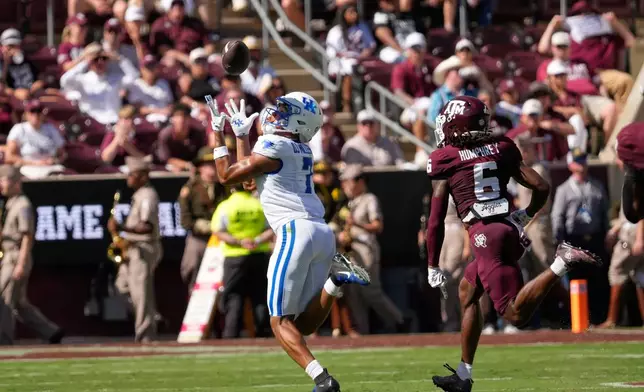 Kentucky wide receiver DJ Miller (7) catches a pass for a first down as Texas A&M cornerback Julio Humphrey (6) defends during the first half of an NCAA college football game Saturday, Sept. 19, 2026, in College Station, Texas. (AP Photo/David J. Phillip)