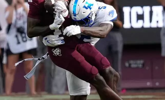 Texas A&M wide receiver Kelshaun Johnson (11) is tackled by Kentucky defensive back Jordan Castell (5) during the second half of an NCAA college football game Saturday, Sept. 19, 2026, in College Station, Texas. (AP Photo/David J. Phillip)