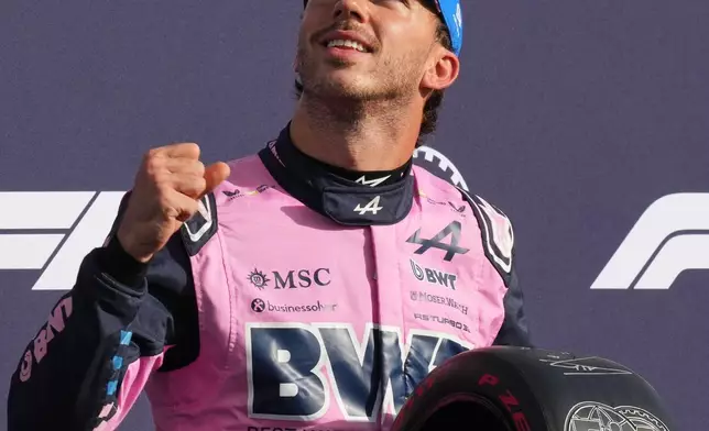 Alpine driver Pierre Gasly of France celebrates with his pole position trophy after the qualifying session ahead of the Italian Formula One Grand Prix, in Monza, Italy, Saturday, Sept. 5, 2026. (AP Photo/Antonio Calanni)