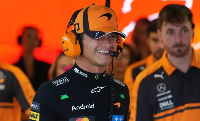 McLaren driver Lando Norris of Britain smiles in his garage during the third free practice ahead of the Italian Formula One Grand Prix, in Monza, Italy, Saturday, Sept. 5, 2026. (AP Photo/Antonio Calanni)