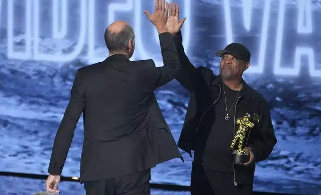Chuck D, right, presents the video vanguard award to Krist Novoselic of Nirvana during the MTV Video Music Awards on Sunday, Sept. 27, 2026, at the Peacock Theater in Los Angeles. (AP Photo/Chris Pizzello)