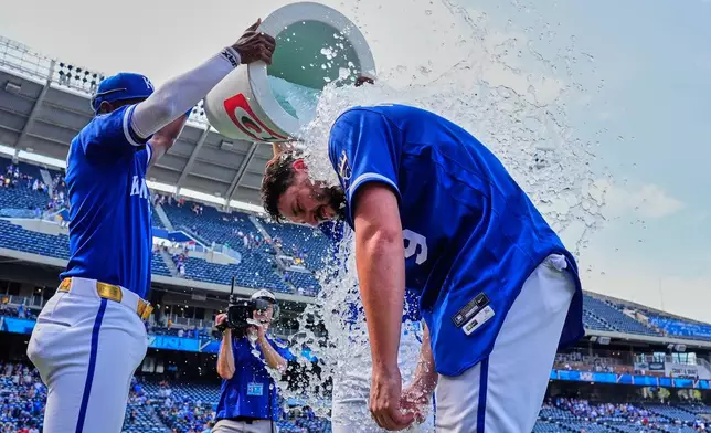 Kansas City Royals' Vinnie Pasquantino (9) is doused by teammates after their baseball game against the Toronto Blue Jays, Sunday, Sept. 6, 2026, in Kansas City, Mo. (AP Photo/Charlie Riedel)