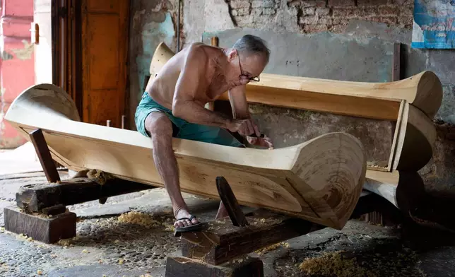 Goh Khuay Par works on a Mei Hua coffin at his family's workshop in Muar, Malaysia, Thursday, Sept. 3, 2026. (AP Photo/Vincent Thian)