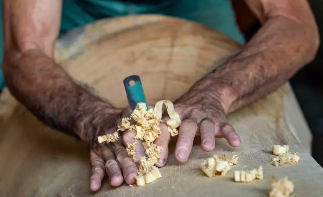 Goh Khuay Par works on a Mei Hua coffin at his family's workshop in Muar, Malaysia, Thursday, Sept. 3, 2026. (AP Photo/Vincent Thian)