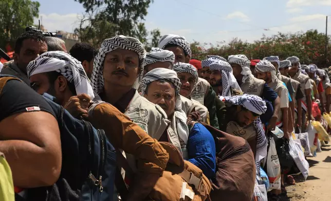 Houthi prisoners freed in Mokha carry their belongings as they arrive in Sanaa, Yemen, Saturday, Sept. 12, 2026, following the Houthi takeover of the southern Red Sea port city. (AP Photo)