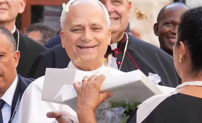 Pope Leo XIV receives a box with butterflies as he arrives at the Basilica Sanctuary of the Mother of Good Counsel in Genazzano, central Italy, Monday, Sept. 7, 2026. (AP Photo/Andrew Medichini)