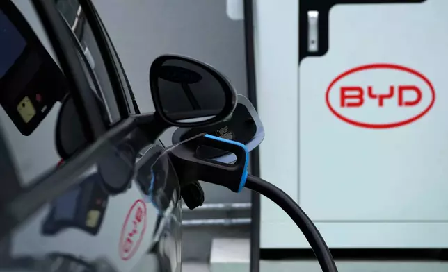 FILE - A BYD electric vehicle charges at a dealership in Camacari, Bahia state, Brazil, Friday, March 7, 2025. (AP Photo/Eraldo Peres, File)