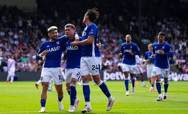 Ipswich Town's Leif Davis, second left, celebrates with teammates after scoring their side's second goal of the game during the English Premier League soccer match between Crystal Palace and Ipswich Town, at Selhurst Park, in London, Saturday, Sept. 12, 2026. (Jordan Pettitt/PA via AP)