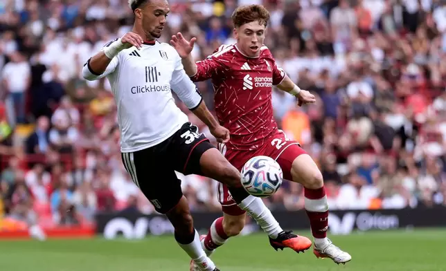Fulham's Antonee Robinson, left, and Liverpool's Victor Munoz battle for the ball during the English Premier League soccer match between Liverpool and Fulham in Liverpool, England, Saturday Sept. 12, 2026. (Peter Byrne/PA via AP)