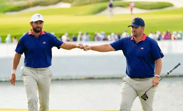 USA teams' Chris Gotterup, right, celebrates with Cameron Young against the International team during a Presidents Cup golf tournament third round foursome match at Medinah Country Club, Saturday, Sept. 26, 2026, in Medinah, Ill. (AP Photo/Chris Carlson)