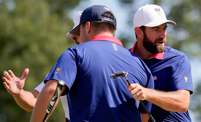 USA teams' Cameron Young, right, celebrates with Chris Gotterup after defeating the International team in their Presidents Cup golf tournament third round four-ball match at Medinah Country Club, Saturday, Sept. 26, 2026, in Medinah, Ill. (AP Photo/Matt Slocum)