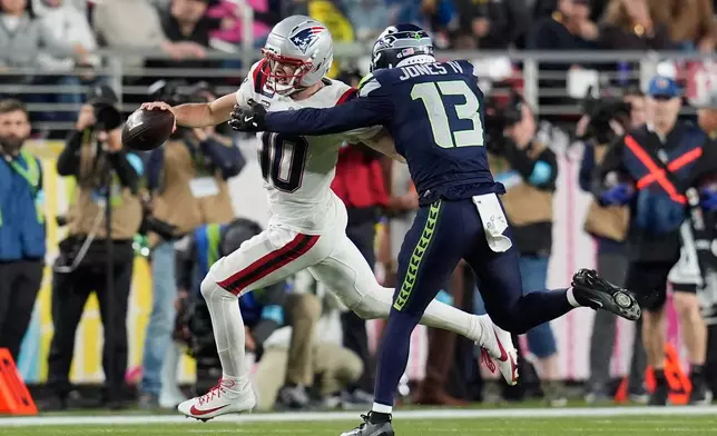 FILE - Seattle Seahawks linebacker Ernest Jones IV (13) tackles New England Patriots quarterback Drake Maye (10) during the NFL Super Bowl 60 football game, Feb. 8, 2026, in Santa Clara, Calif. (AP Photo/Steve Luciano, File)