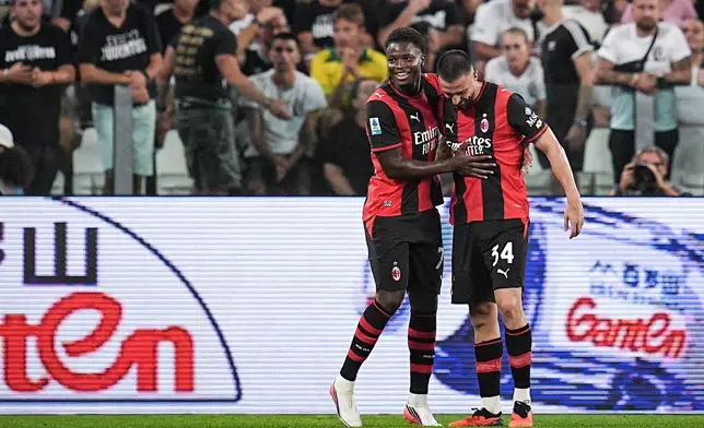 AC Milan's Alphadjo Cisse, left, celebrates scoring against Juventus during a Serie A soccer match in Turin, Italy, Sunday, Sept. 6, 2026. (Marco Alpozzi/LaPresse via AP)