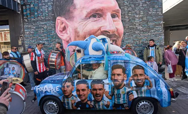 FILE - People sing happy birthday to Lionel Messi at a street mural of him in Buenos Aires, Argentina, June 24, 2026. (AP Photo/Rodrigo Abd, File)