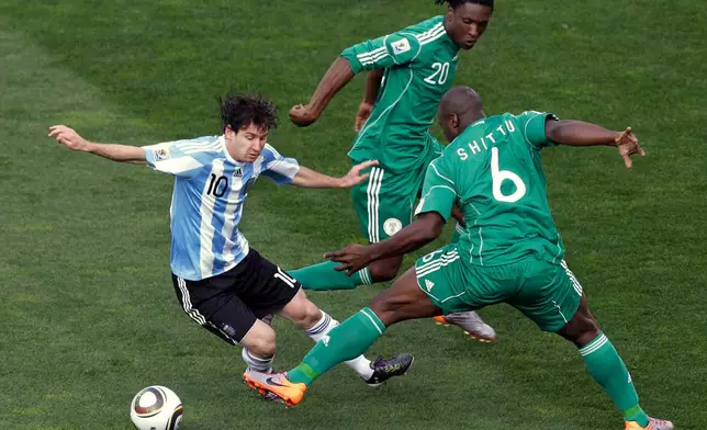 FILE - Argentina's Lionel Messi, left, competes for the ball with Nigeria's Danny Shittu, right, and Nigeria's Dickson Etuhu, center, during the World Cup group B soccer match in Johannesburg, South Africa, June 12, 2010. (AP Photo/Hassan Ammar, File)