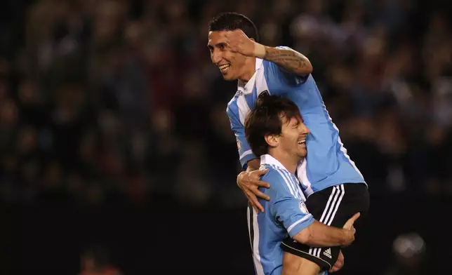FILE - Argentina's Angel Di Maria, top, celebrates with Argentina's Lionel Messi after scoring against Ecuador during a World Cup 2014 qualifying soccer game in Buenos Aires, June 2, 2012. (AP Photo/Ivan Fernandez, File)