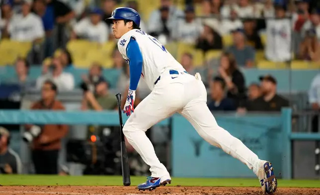 Los Angeles Dodgers' Shohei Ohtani heads to first for a double during the ninth inning of a baseball game against the San Diego Padres, Thursday, Sept. 24, 2026, in Los Angeles. (AP Photo/Mark J. Terrill)