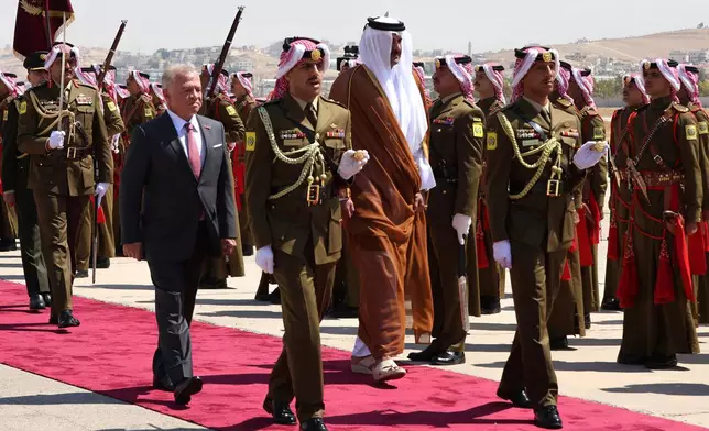 FILE - Jordan's King Abdullah II, left, and Qatar's Emir Tamim bin Hamad Al-Thani, review an honour guard during a welcome ceremony in Amman, Jordan, Wednesday, Sept. 17, 2025. (AP Photo/Raad Adayleh, File)