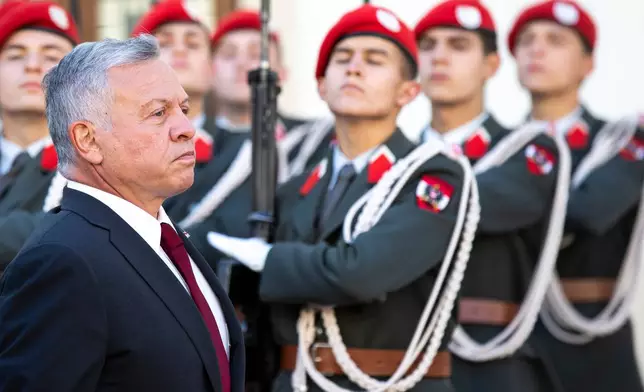 FILE - The King of Jordan, Abdullah II bin al-Hussein, left, attends a military ceremony with Austrian President Alexander Van der Bellen in Vienna, Austria, Monday, Oct. 25, 2021. (AP Photo/Lisa Leutner), File