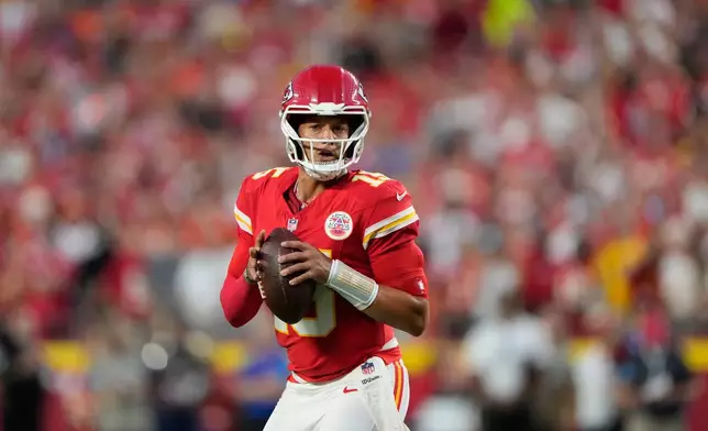 Kansas City Chiefs quarterback Patrick Mahomes looks to pass against the Denver Broncos during the first half of an NFL football game Monday, Sept. 14, 2026, in Kansas City, Mo. (AP Photo/Charlie Riedel)