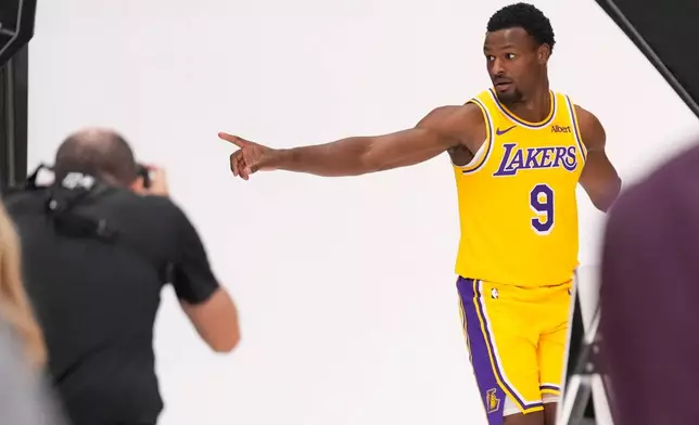 Los Angeles Lakers guard Bronny James poses for pictures with NBA photographer Adam Pantozzi during media day Monday, Sept. 28, 2026, in El Segundo, Calif. (AP Photo/Mark J. Terrill)