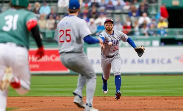 Chicago Cubs infielder Michael Busch flips a ground ball hit by Boston Red Sox' Adley Rutschman to pitcher Clay Holmes for an out during the first inning in the the first baseball game of a doubleheader, Friday, Sept. 25, 2026, in Boston. (AP Photo/Greg M. Cooper)