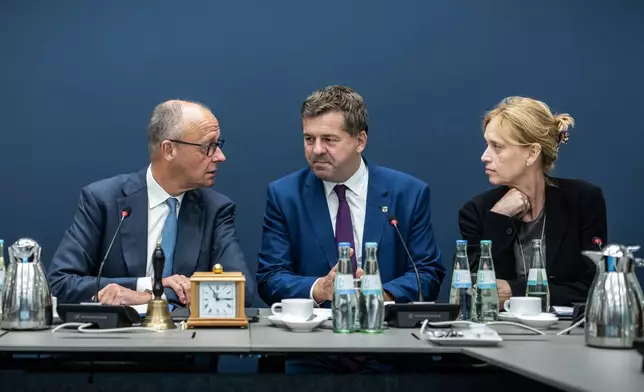 From left, Chancellor Friedrich Merz, Sven Schulze, Minister-President of Saxony-Anhalt and state chairman of the CDU in Saxony-Anhalt, his party's top candidate for the state election on Sept. 6, and Karin Prien, Federal Minister of Education, Family, Senior Citizens, Women, and Youth, and Deputy Chair of the CDU Federal Executive Committee, attend the meeting of the CDU Federal Executive Committee at the Konrad Adenauer House, in Berlin, Monday, Sept. 7, 2026. (Michael Kappeler/dpa via AP)
