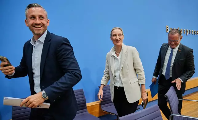 Co-leaders of Alternative for Germany party, or AfD, Alice Weidel, center, and Tino Chrupalla, right, and top candidate for the Saxony-Anhalt state elections Ulrich Siegmund, left, leave a press conference in Berlin, Germany, Monday, Sept. 7, 2026. (AP Photo/Ebrahim Noroozi)