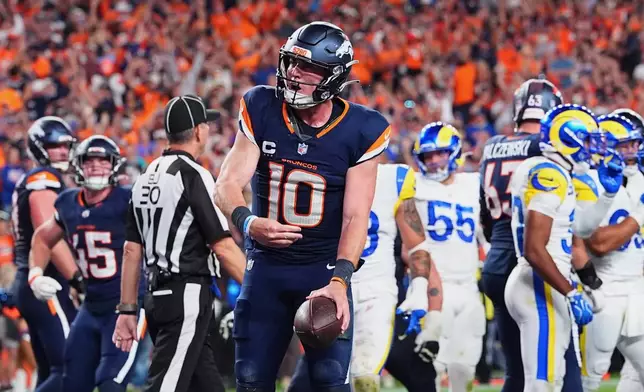Denver Broncos quarterback Bo Nix reacts after scoring a touchdown against the Los Angeles Rams during the second half of an NFL football game Sunday, Sept. 27, 2026, in Denver. (AP Photo/David Zalubowski)