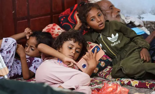 Displaced Yemenis rest at a temporary shelter in the Dar Saad district of Aden, Yemen, Saturday, Sept. 12, 2026, after fleeing Houthi attacks in the western coastal cities of al-Khokha and Mokha. (AP Photo/Abdulnasser Alseddik)