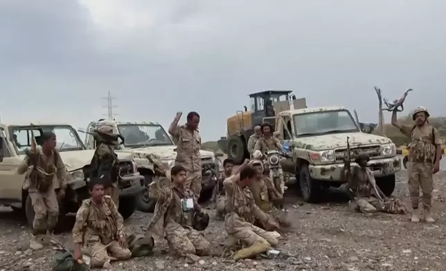 This image taken from undated video released by the Ansar Allah Media Office, the media arm of Yemen's Houthi rebels, on Saturday, Sept. 12, 2026, shows Houthi fighters chant after praying beside military vehicles during what the group says was their advance against Saudi-backed forces at an undisclosed location in southern Yemen. (Ansar Allah Media Office via AP)