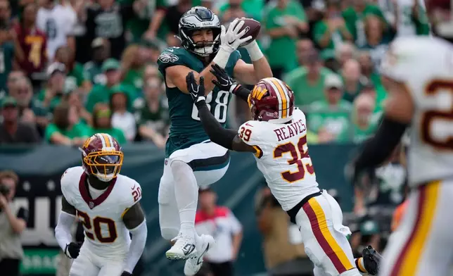 Philadelphia Eagles tight end Dallas Goedert (88) catches a pass over Washington Commanders safety Jeremy Reaves (39) for a touchdown during the first half of an NFL football game, Sunday, Sept. 13, 2026, in Philadelphia. (AP Photo/Matt Slocum)