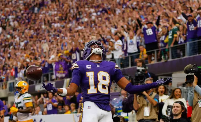 Minnesota Vikings wide receiver Justin Jefferson (18) celebrates after catching two-point conversion pass during the second half of an NFL football game against the Green Bay Packers, Sunday, Sept. 13, 2026, in Minneapolis, Minn. (AP Photo/Bailey Hillesheim)