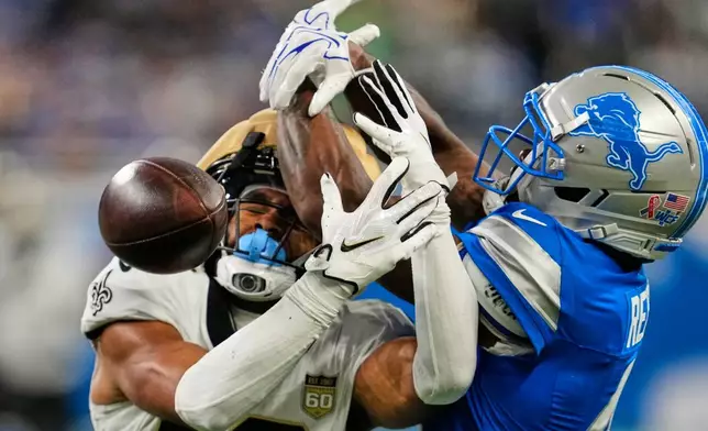 Detroit Lions cornerback D.J. Reed (4) breaks up a pass intended for New Orleans Saints wide receiver Chris Olave (12) in the first half of an NFL football game, Sunday, Sept. 13, 2026, in Detroit. (AP Photo/Paul Sancya)