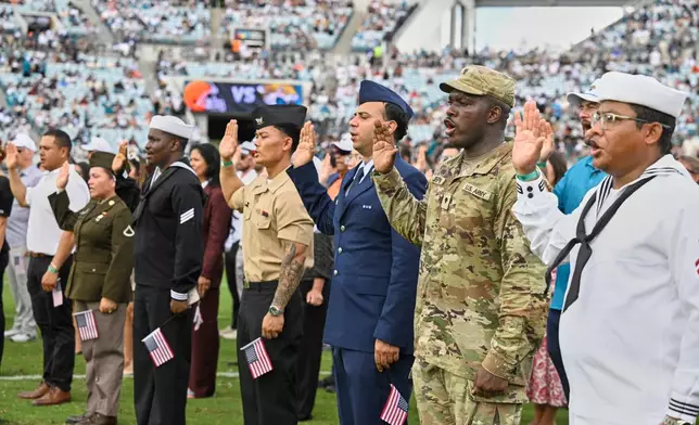 New citizens are sworn in at halftime of an NFL football game between the Cleveland Browns and the Jacksonville Jaguars, Sunday, Sept. 13, 2026, in Jacksonville. (AP Photo/Phelan M. Ebenhack)