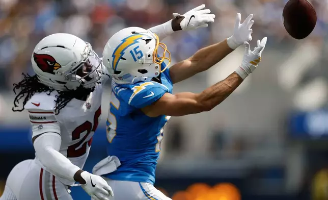 Arizona Cardinals cornerback Denzel Burke, left, defends against a pass intended for Los Angeles Chargers wide receiver Ladd McConkey (15) during the first half of an NFL football game, Sunday, Sept. 13, 2026, in Inglewood, Calif. (AP Photo/Caroline Brehman)