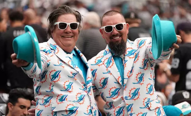 Fans react before an NFL football game between the Las Vegas Raiders and the Miami Dolphins, Sunday, Sept. 13, 2026, in Las Vegas. (AP Photo/Ross D. Franklin)