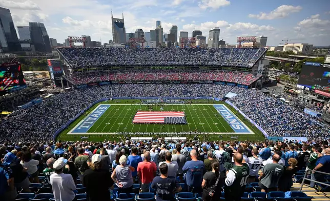 Fans stand for the National Anthem at the start of an NFL football game between the Tennessee Titans and the New York Jets, Sunday, Sept. 13, 2026, in Nashville, Tenn. (AP Photo/John Amis)
