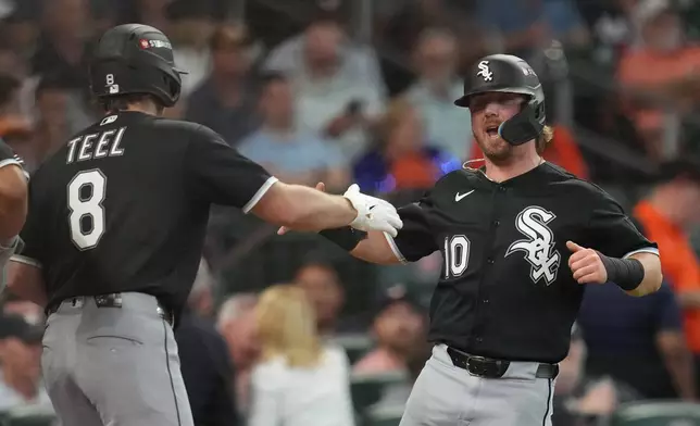 Chicago White Sox's Chase Meidroth (10) celebrates with Kyle Teel (8) after scoring off a 2-run single hit by by Sam Antonacci during the second inning in Game 1 of baseball's American League Wild Card Series against the Houston Astros, Tuesday, Sept. 29, 2026, in Houston. (AP Photo/Karen Warren)